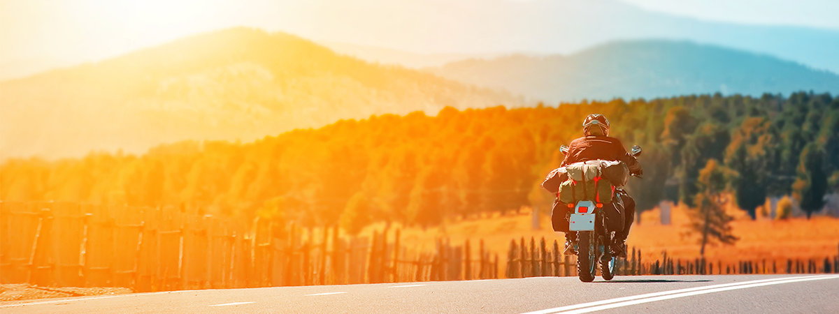 Man riding his motorcycle at sunset