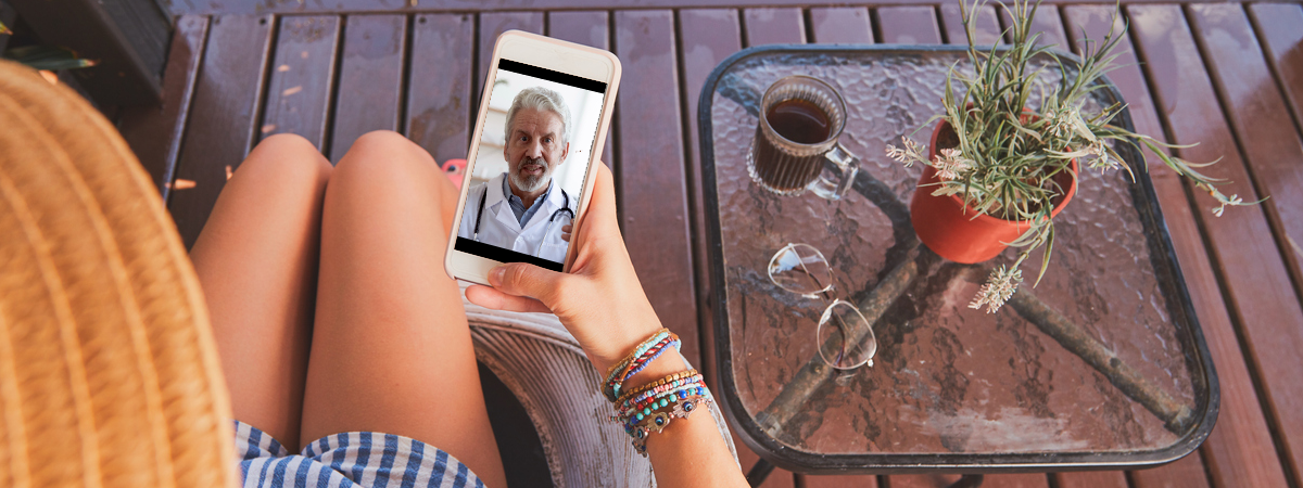 Woman video calling doctor from home.