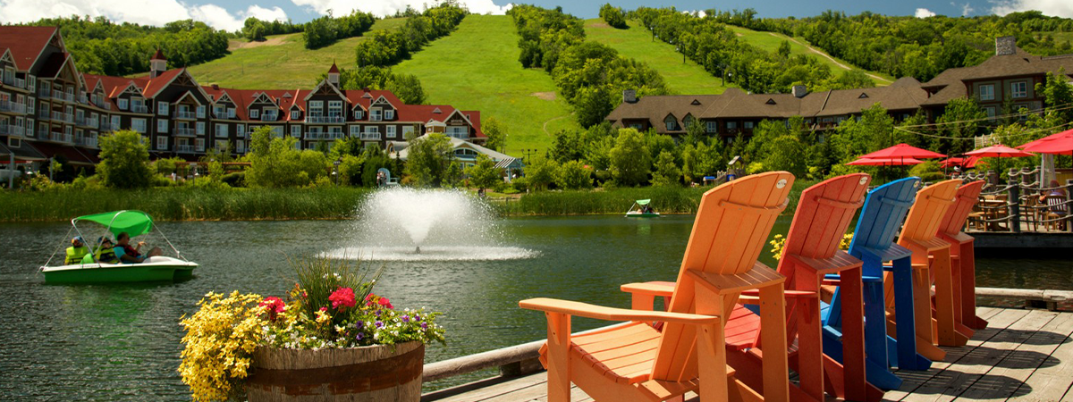 Adirondack chairs overlooking the nearby pond in the Blue Mountain Village