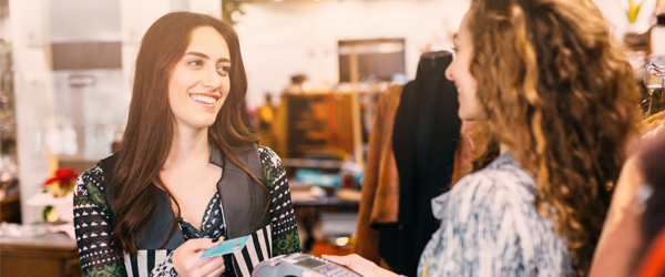 Woman making transaction in clothing store.