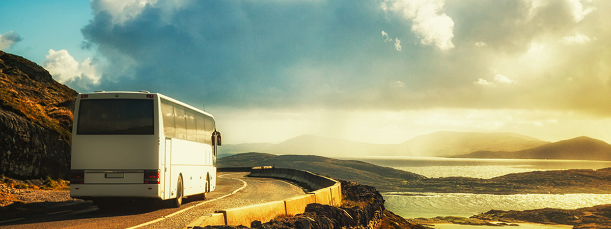 Coach bus driving through stunning landscape