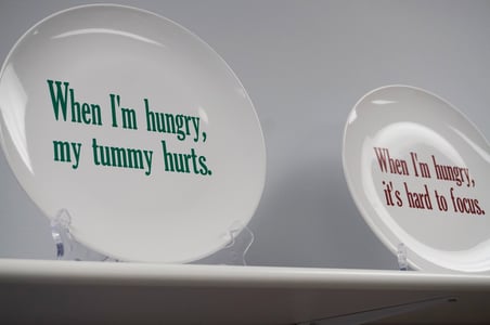 Plates displaying messages of the importance of food for children.