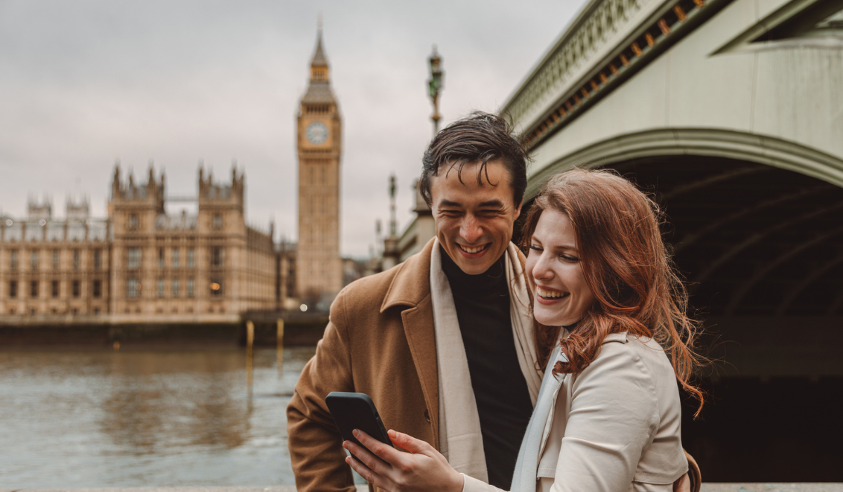 Couple smiling at phone in Europe