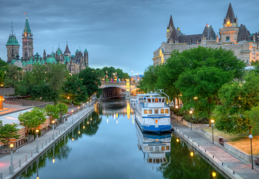 Parliament Hill along the banks of the Rideau Canal in Ottawa Ontario. Parliament Hill is home to Canada's federal government and is the centrepiece of Ottawa’s downtown landscape. Ottawa is known for is high-tech business sector, vast array of museums and high standard of living.