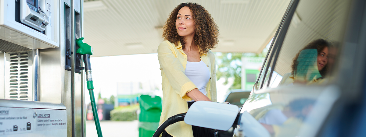 Woman pumping fuel into her car