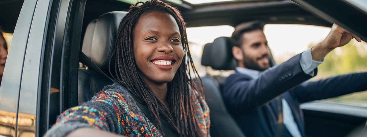 Woman with group of people in a car together, ride sharing in city,