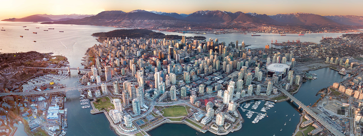 Aerial panoramic view of downtown Vancouver with mountains in the background