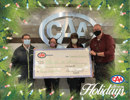 From left: A Meals on Wheels organizer, Cheryl Henderson, Dolores Jasmine, and Peter Van Hezewyk hold Meals on Wheels donation made by CAA Niagara's Light up the Holidays initiative.