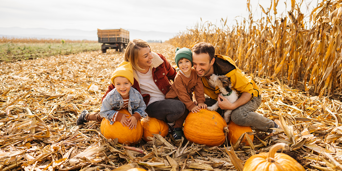 Family having fun at a pumpkin patch