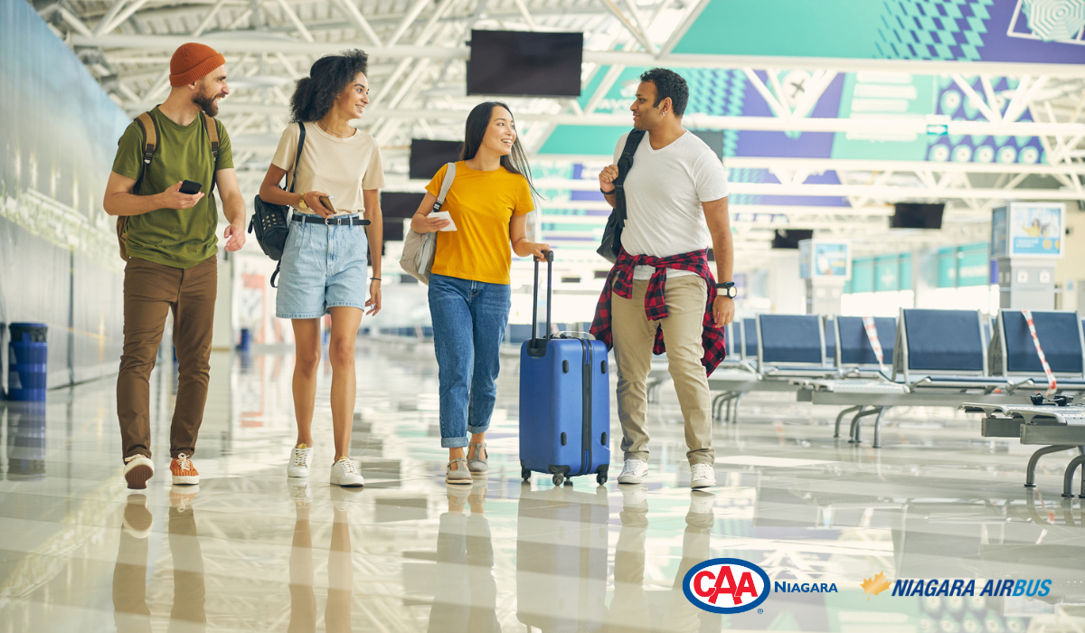 group of friends happily walking through airport