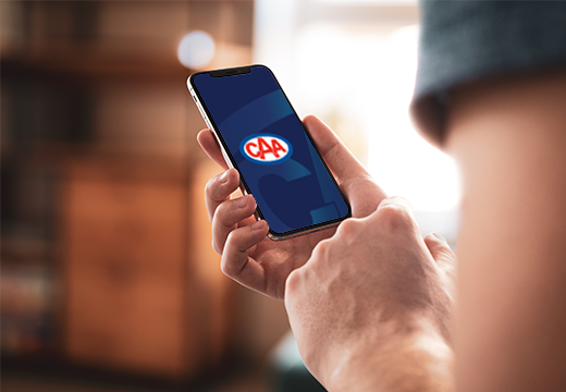 Man holding the CAA Mobile App