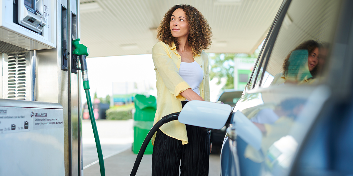 Woman pumping fuel into her car