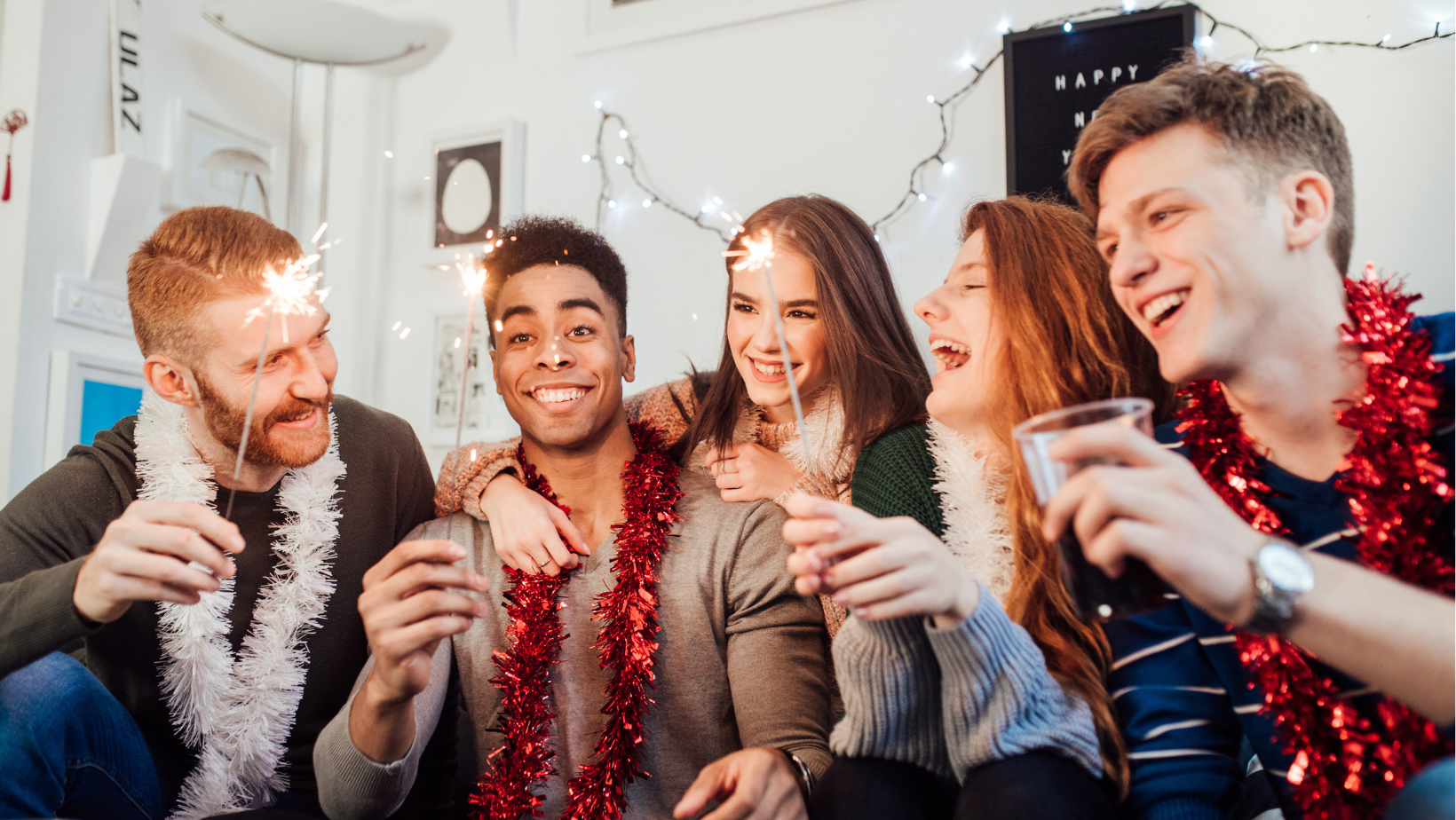 People holding sparklers at house party