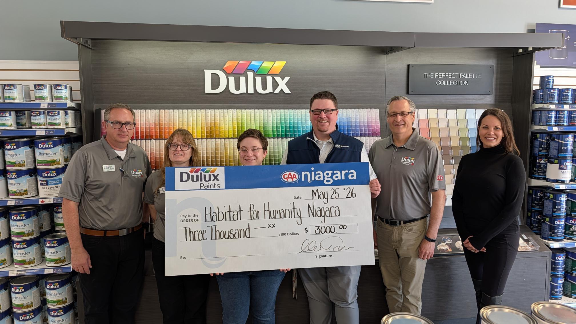 Dulux Paints, CAA Niagara and Habitat for Humanity Staff holding large cheque for $3,000